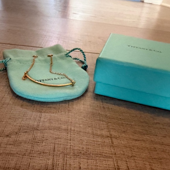 Tiffany & Co. Jewelry - Tiffany & Co. Gold Curved Bar bracelet with Blue Pouch